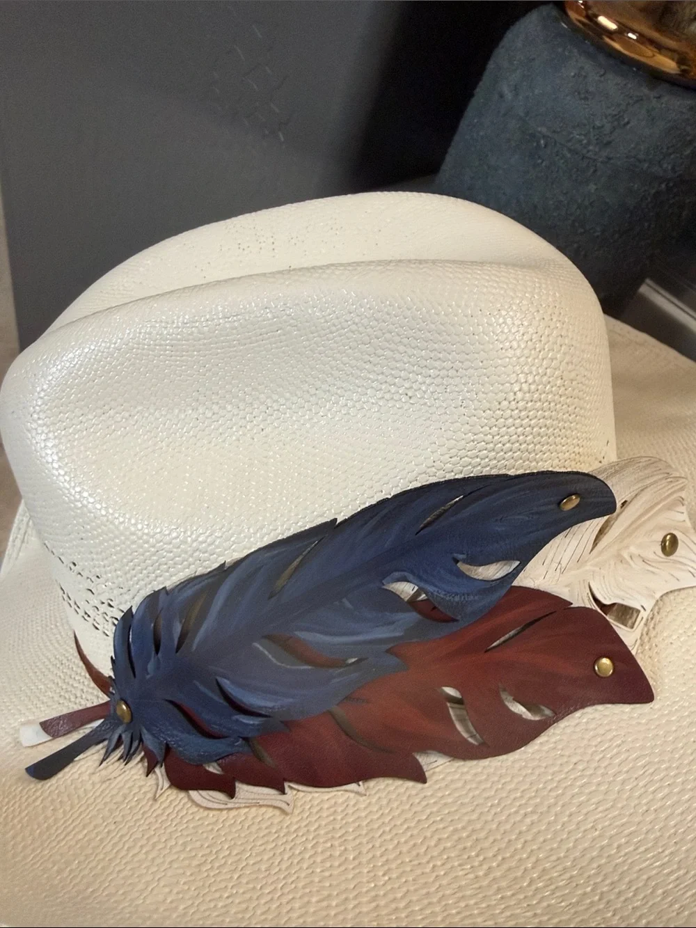 White Straw Cowboy Hat with Patriotic Red White and Blue Feathers.